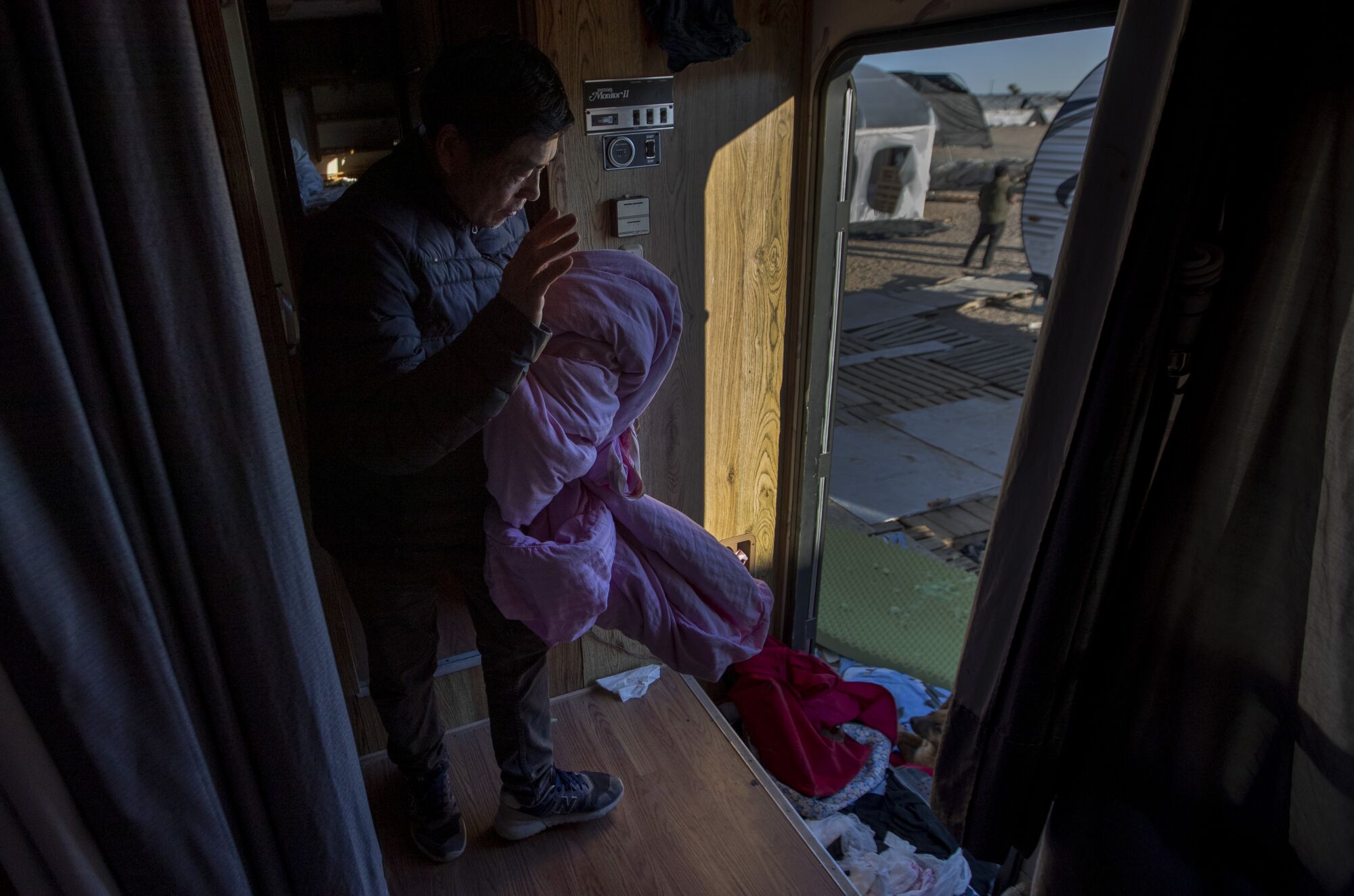  A worker gathers his belongings inside a trailer.